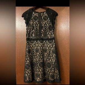 Black, cocktail dress. Fringe sleeves and neckline. Super cute on